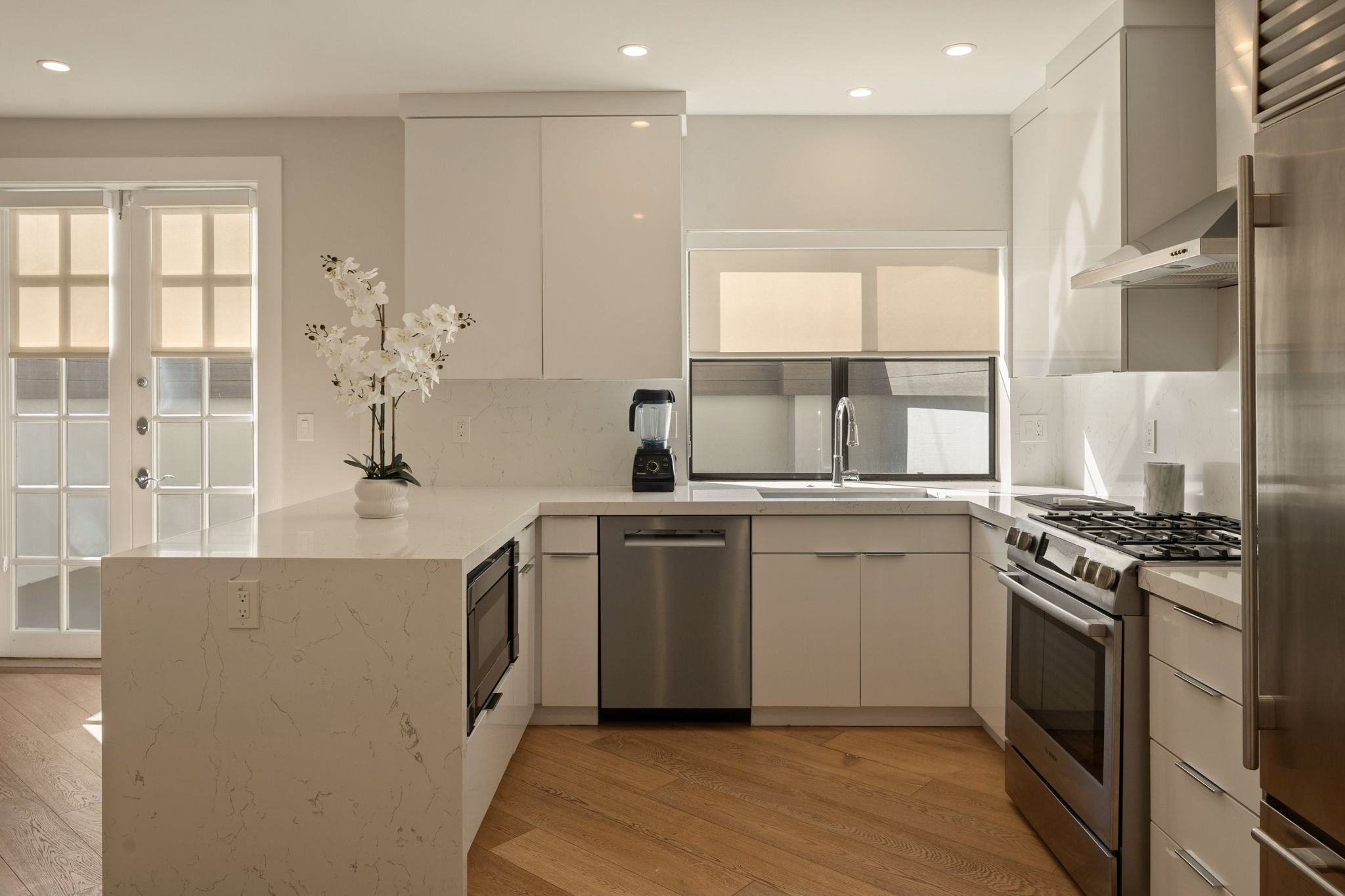 241 S Lasky Drive &mdash; kitchen with quartz counters and French doors